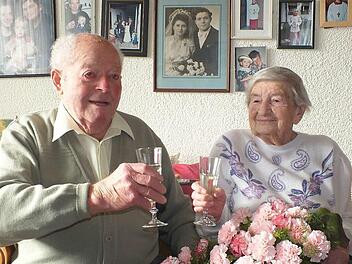 Hans und Erna Mayer beim Anstoßen auf den Hochzeitstag und vor 70 Jahren (auf dem Bild an der Wand) bei ihrer Hochzeit Foto: Manfred Welker