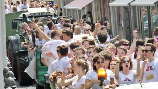 Jubelnde Abiturienten ziehen auf Wagen, gezogen von Traktoren, durch die Innenstadt. Fotos: Corinna Igler