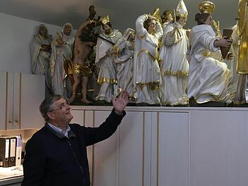 Pfarrer Wolf schaut in der Sakrestei nach den Heiligenfiguren.  Fotos: Franz Galster