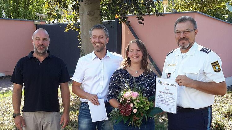 Mit Urkunde und Blumen bedankte sich Bad Brückenaus Polizeichef Herbert Markert (rechts) bei Johanna Leitsch. Auch der Ermittlungsbeamte Steffen Trabert (links) und Mottens Bürgermeister Jochen Vogel (2.v.l.) lobten das besonnene Vorgehen der 33-jährigen Bäckermeisterin aus Speicherz. Foto: Rolf Pralle