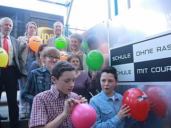 Die Schulleiter Bernd Lohneiß (Gymnasium, hinten links) und Michael Ulbrich (Mittelschule, hinten rechts) zeigen gemeinsam mit den Organisatorinnen Sonja Größler (hinten Mitte) und Petra Arnold (rechts in der zweiten Reihe von hinten) und weiteren Lehrerinnen und Schülern die Ballons für den Flashmob.Foto: Maria Leicht