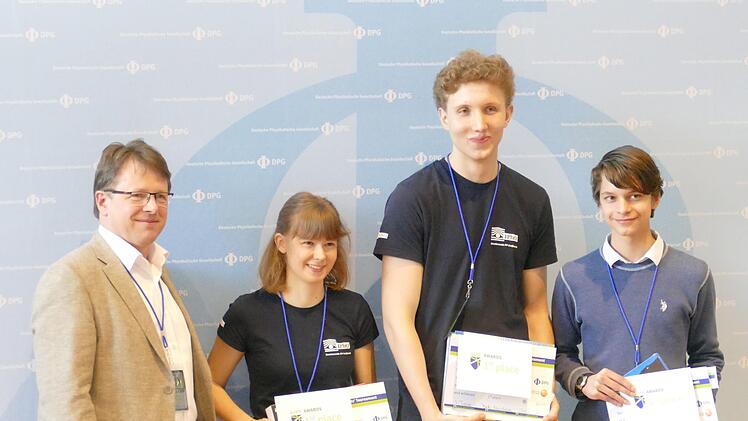 Das Siegerteam der Deutschen Physikmeisterschaft wurde vom TAO-Schülerforschungszentrum an der Universität Bayreuth betreut: Saskia Drechsel vom Glückauf-Gymnasium in Dippoldiswalde, Thomas Kornalik vom Ehrenbürg-Gymnasium in Forchheim und Tarik Becic vom Frankenwald-Gymnasium in Kronach (v.l.). Links im Bild Lutz Schröter, designierter Präsident der Deutschen Physikalischen Gesellschaft. Foto: W. Zimmermann