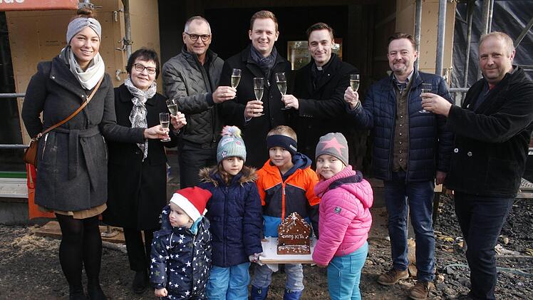 Auf das Richtfest stie&szlig;en (von links) die Erzieherinnen Anna Schild, Petra Bartenstein, Architekt Roland Schulthei&szlig;, B&uuml;rgermeister Tobias Ehrlicher, Pfarrer Simon Meyer, Architekt Steffen Fischer (Kirchengemeindeamt) und Zimmermann Erik Thiel an.Martin Rebhan