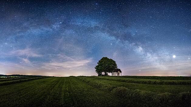 Sternenhimmel &uuml;ber Feld mit Kapelle und Baum in der Oberpfalz in Bayern.