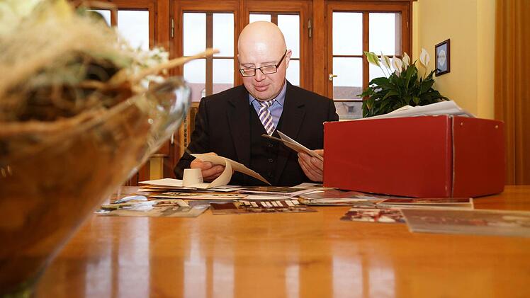 Dieter Densch durchstöbert die Andenken an die Paare, die bei ihm den Bund fürs Leben geschlossen haben. Foto: Arkadius Guzy