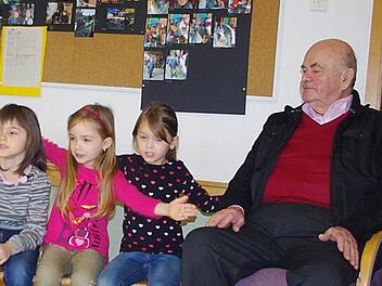Hanna, Luisa und Leonie (v. l.) stimmen in die Lieder mit ein. Walter Klose freut sich darüber. Foto: Heike Schülein