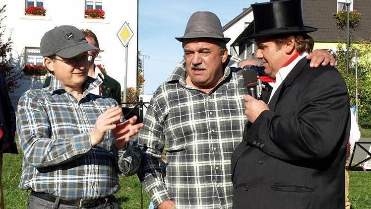 Erklärt Pater Jan, wie man Hühner fängt? Peter Hänel und Thomas Schütz (rechts, Kirchweihkomitee) passen ganau auf.