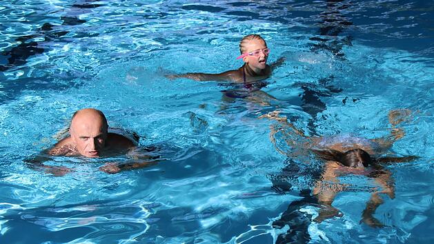 Auf der Bahn: Leonie und Lara schwammen mit Landrat Wilhelm Schneider (von rechts) Meter f&uuml;r Meter und trugen damit zum Gesamtergebnis f&uuml;r die Aktion im Hofheimer Hallenbad bei.  Foto: Klaus Schmtt