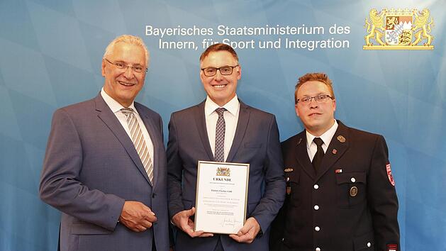 Verleihung der Auszeichnung "Ehrenamtsfreundlicher Betrieb": (von links) Innenminister Joachim Herrmann, Markus Fischer und Alexander Beck von der Firma Elektro Fischer. Foto: Giulia Iannicelli/stmi