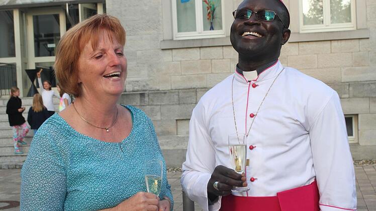 Auf ihre Freundschaft stießen Andre Gueye (rechts) und Roswitha Burger an. Scherzhaft meinte der Bischof, Roswitha Burger habe doch jetzt im Ruhestand Zeit und könne seine Sekretärin werden.