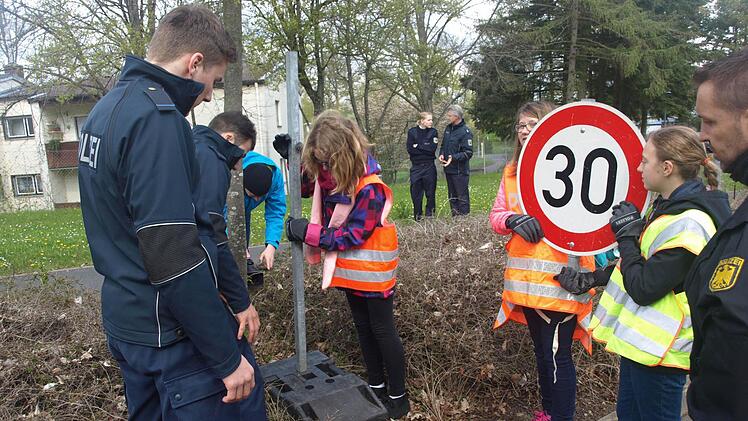 Ausgestattet mit Warnwesten helfen Schülerinnen beim Aufbau einer Straßenkontrolle mit. Foto: Stefan Geiger