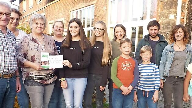 Von links: G&uuml;nther Scheler, Sabine Scherbel (AK Familie), Evi Scheler, Natascha Christmann (Struwwel), Sophia Wagner, Emma Schneider, Nicole Backer (AK Familie), Geschwister Backer, Samuel Rauch, Kristina Fritz (Struwwel), Emma Christmann und 2. B&uuml;rgermeisterin Angela Hofmann freuen sich &uuml;ber die Spende des M&auml;dchen-Caf&eacute;s. Foto: Heike Sch&uuml;lein