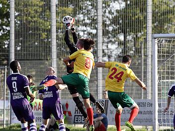FCE-Torwart fängt einen Eckball sicher. Die DJKler Johannes Wolfschmidt (Nr. 8) und Christopher Kettler (Nr. 24) gehen leer aus. Foto: sportpress