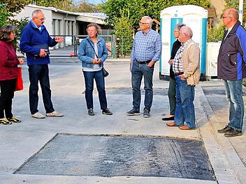Zu Beginn der wegen Beschlussunfähigkeit nicht durchgeführten Sitzung des  Rannunger Gemeinderates schauten sich die erschienenen Mitglieder in der  Straße am Hock, direkt am Rathaus um. Hier sollen im Zuge der Arbeiten auf  dem Schul- und Kirchhof der Gehweg und die Straße erneuert werden. Foto:  Dieter Britz