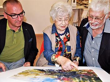 Gabriele Waldmann erklärt Bürgermeister Andreas Sandwall (links) und Altbürgermeister Wolfgang Back ein Aquarell ihres Ehemannes, des Aquarellisten Emil Waldmann (1925-2012).  Foto: Sigismund von Dobschütz