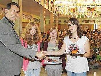 Bürgermeister Roland Wolfrum überreichte den drei Aktiven des Schullädlas Sachpreise: Jasmin Heusinger, Lisa Frankenberger und Laura Spindler. Foto: Sonja Adam