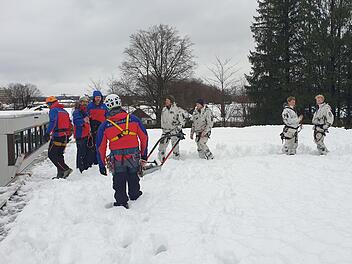 Gemeinsam mit einer Gruppe von Gebirgsjägern haben Helfer der Bergwachtbereitschaft Kulmbach-Obermain das Dach einer Schule vom Schnee befreit. Foto: Bergwacht