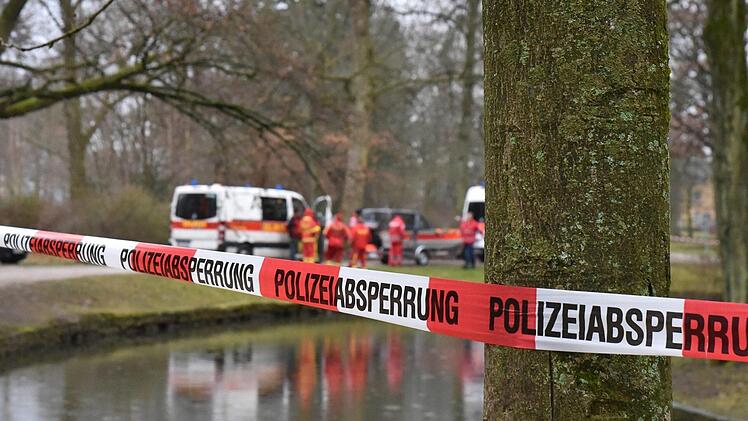 Die Rettungskräfte des DLRG stehen an einem Kanal im Hofgarten. Passanten hatten in dem Kanal einen Toten entdeckt. Die Kripo ermittelte, dass der Mann ertrunken ist. Foto: Rudi Ziegler/dpa