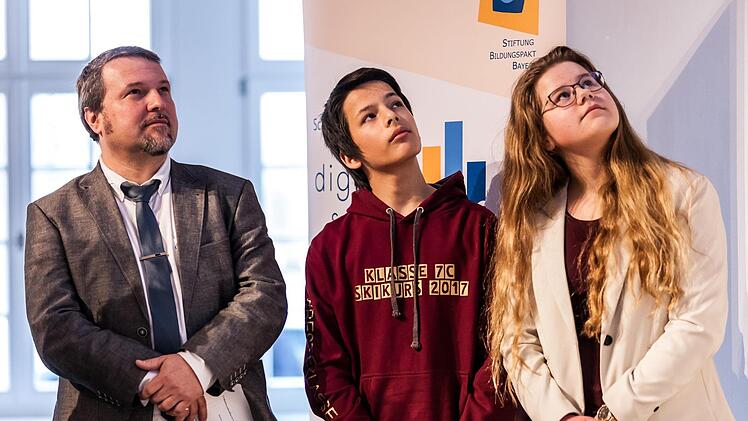 Schulleiter Philipp Arnold und die Achtklässler Julian Jarski und  Carolin Jakob (von links) präsentierten in München Projekte der digitalen Modellschule in Ebern. privat