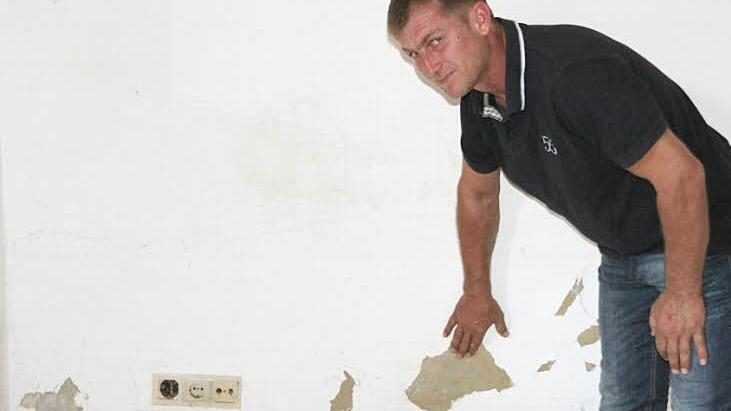 Ein unansehnlicher Anblick: Putz bröckelt im Erdgeschoss des Mainecker Gemeindehauses von der Wand, die mit schwarzen Schimmelflecken übersät ist. Zweiter Bürgermeister Georg Deuerling machte sich ein Bild von den Schäden.