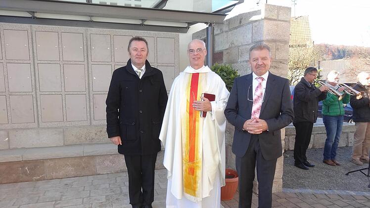 Segnung der neuen Urnenwandanlage durch Pfarrer Manfred Endres (Mitte) mit Bürgermeister Udo Baumann (links) und Pfarrgemeinderatsvorsitzender Bernhard Eisenmann (rechts). Foto: Eckert