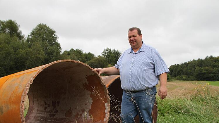 Der Brunnenschacht hat im oberen Bereich einen Durchmesser von 1,20 Meter. Bürgermeister Bernold Martin demonstriert die Größe. Foto: Ulrike Müller