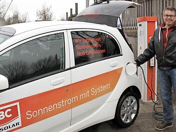 FT-Redakteur Matthias Einwag beim Betanken eines elektrisch betriebenen Mitsubishi iMiev an der Ladestation der Therme, die sich vor dem ehemaligen Kreishallenbad befindet. Foto: Diana Geißendorfer