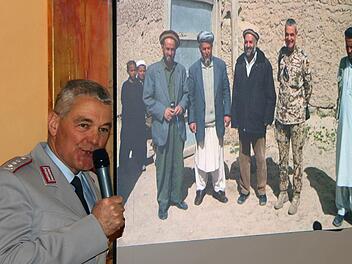 Zweimal Oberst i.G. Peter Utsch: Links bei seinem Vortrag im Erzählcafé im Haus St. Michael. Rechts auf einem per Beamer projizierten Bild zusammen mit einheimischen afghanischen Politikern.  Foto: Dieter Britz