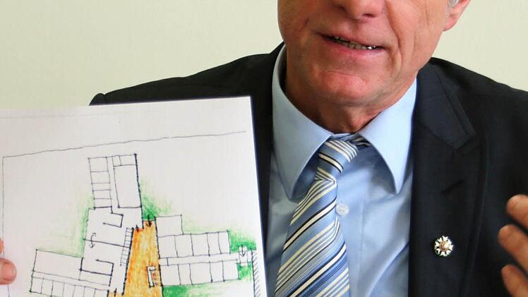 Blick in die Zukunft: Vorstandsvorsitzender Ulrich Eberhardt-Schramm zeigt den Plan für das geplante Schülerinternat mit vier Bungalows. Foto: Bettina Knauth