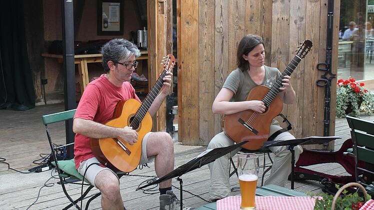 Stefan Grasse und Yvonne Zehner greifen in einem Ebermannstadter Biergarten zu ihren Gitarren.  Foto: Carmen Schwind