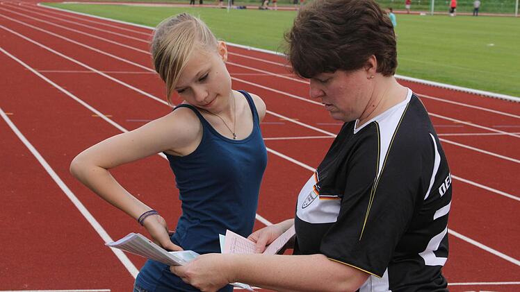 Julia und Alexandra Podschun studieren die neuen Bedingungen des Deutschen Sportabzeichens.