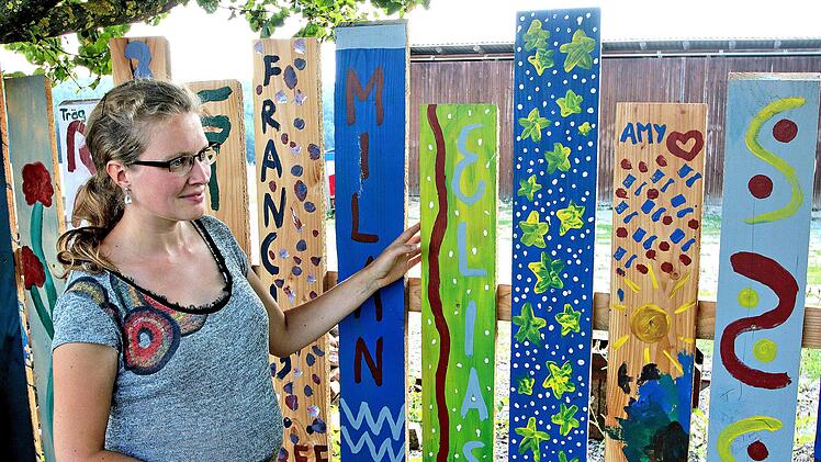 Zu Kunstwerken sind die Zaun-Bretter am Spielplatz auf den Johannisberg  geworden. Unter dem Motto "generationenübergreifende Spielplatzgestaltung"  haben viele Bürgerinnen und Bürger, auch zahlreiche Kinder, mitgeholfen.  Links die Quartiermanagerin Nathalie Langer, die die Aktion angestoßen hat. Foto: Dieter Britz