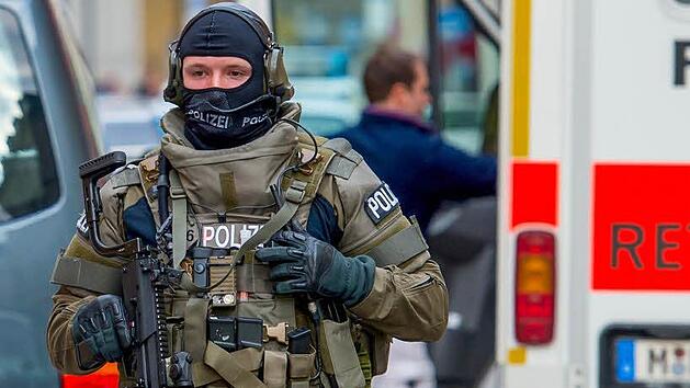 Ein SEK-Beamter r&uuml;ckt in voller Montur zu einem gef&auml;hrlichen Einsatz aus.  Foto: Sven Hoppe, dpa