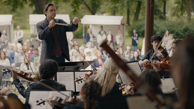 Florian Messerschmidt (Alexander Beyer) dirigiert das Konzert des gemischten Orchesters, das Marianne Bach initiiert hat. Er spielte eine große Rolle im Leben der Ermordeten und könnte auch eine Rolle in ihrem Tod gespielt haben.