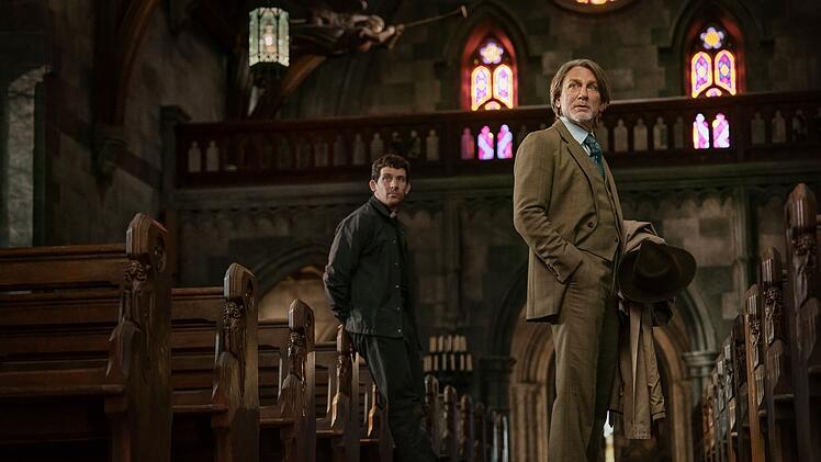 Niemand kann so gut Dandy-Anzüge mit einem Südstaaten-Dialekt kombinieren wie Meisterdetektiv Benoît Blanc (Daniel Craig). Das muss auch der junge Priester Jud Duplenticy (Josh O'Connor) anerkennen.