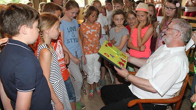 Die 4. Klasse überreicht dem Schulleiter ein gebasteltes Buch. Foto: Gerd Klemenz