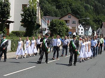 Die Fahne mit Begleitern des gastgebenden Vereins führte den Schützenumzug durch die Flößerstadt Wallenfels an. Stark vertreten waren auch der Stadtrat und der Pfarrgemeinderat. Foto: Michael Wunder