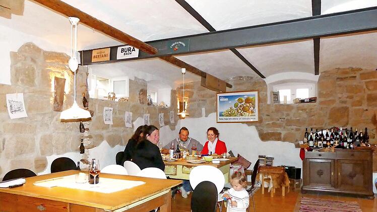Alexander und Jessica Fuchs (hinten) mit Hausgästen in ihrer Vinothek, einem ehemaligen Schweinestall Foto: Dieter Hübner