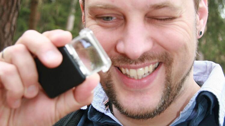 Auch Biologielehrer Andreas Bock nimmt die Stöcke im Waldboden genau unter der Lupe. Aber auch er kann nichts entdecken.