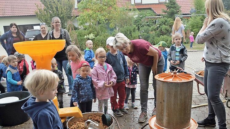 Aus einer mobilen Saftpresse gewinnen die Kinder in Trailsdorf frischen Apfelsaft.  Foto: Mathias Erlwein