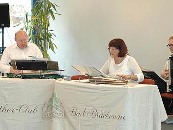 Guido Wolf, Elke Hüfner sowie Marco Wolf (Ziehharmonika) spielen mit ihrer Gruppe auch moderne Zither-Musik. Foto: Sebastian Schmitt-Mathea
