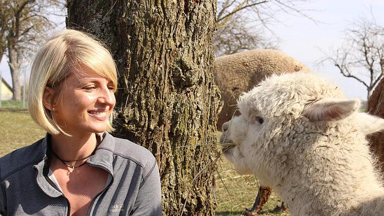 Liebe auf den ersten Blick: Johanna Fischer und Reiki, das jüngste der vier Alpakas. Fotos: Nina Grötsch