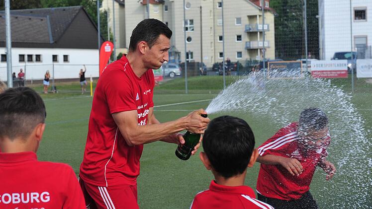 Auf dem Platz eine Klasse für sich - beim Feiern ganz vorn: Daniel Sam nach dem Landesliga-Aufstieg mit Coburger Jungs. Der Mittelstürmer der Vestekicker spielte für den 1. FC Nürnberg, die SpVgg Selbitz, den FC Bayern Hof, die SpVgg Bayreuth und den VfL Frohnlach. Die Sektkorken ließ er in den letzten 15 Jahren öfters knallen, denn seine Amateurkarriere ist gespickt mit außergewöhnlichen Höhepunkten. Foto: Hagen Lehmann