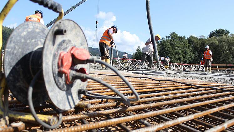 In zwei Schichten arbeiteten 30 Bauarbeiter daran, den Beton zu verteilen. Beigemischt waren ihm zwei Chemikalien. Eine sorgt dafür, dass er flüssig genug ist, um hochgepumpt werden zu können, die andere dafür, dass der Beton nicht sofort anfängt, zu binden. Foto: Marian Hamacher