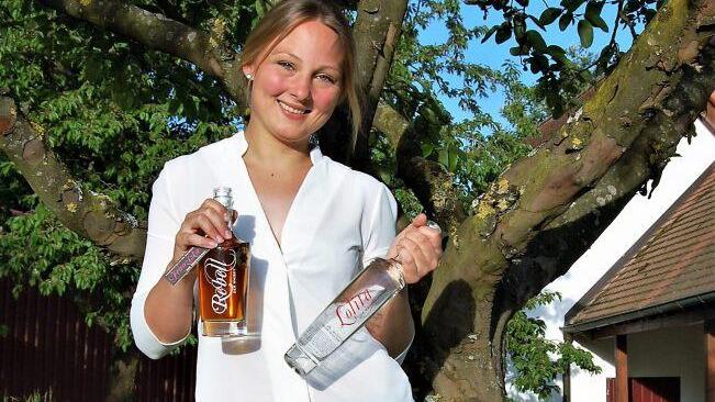 Unterm Quittenbaum: Brennerin Franziska Bischof mit Beispielen ihrer Obstbrände.  Foto: Sigismund von Dobschütz