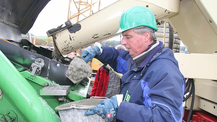 Mit einer Kelle nimmt Matthias Müller eine Betonprobe direkt aus dem Auto. Foto: Sonny Adam