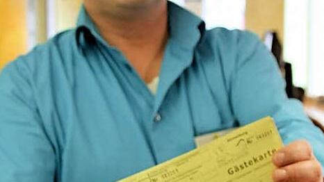 Markus Alin vom Staffelsteiner Kur- und Tourismus-Service mit einem Block Gästekarten, die in der Kurstadt an die Vermieter von Ferienwohnungen ausgegeben werden. Foto: Matthias Einwag