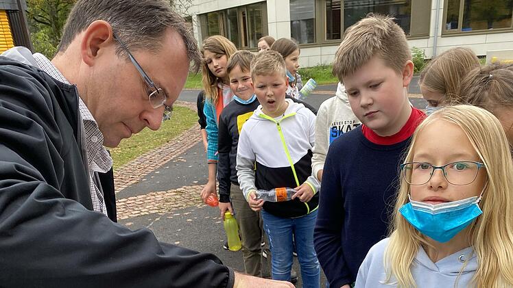 Waschen, pressen, trinken: Der eigenhändig zubereitete frische Apfelsaft schmeckt. Realschul-Direktor Michael Kreil schenkt den Fünftklässlern ein.