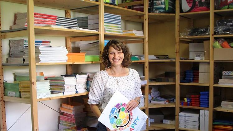 Sozialpädagogin Tanja Völker vor den voll gefüllten Grünstift-Regalen. Hochwertiges Schulmaterial und Schulranzen werden ausgegeben. Fotos: Christiane Lehmann