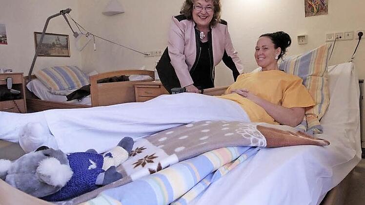 Victoria Hickling darf Probeliegen im Niederflurbett. Heimleiterin Lydia Kropfelder (links) freut sich über fünf solcher Betten.  Foto: Josef Hofbauer